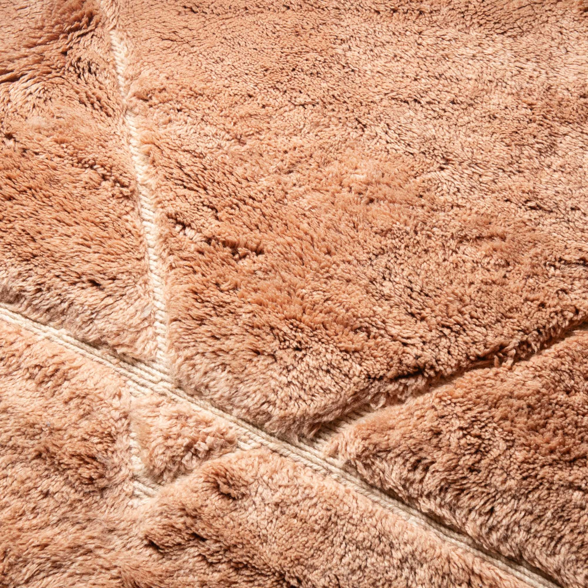 closeup Handmade Moroccan wool rug golden ochre with carved ivory geometric triangles