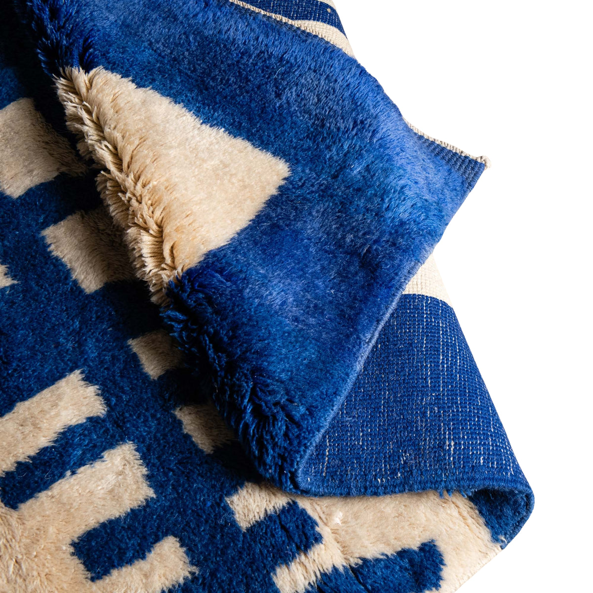 flipped closeup Azure Grid handmade Mrirt Moroccan wool rug in cobalt blue and ivory geometric design