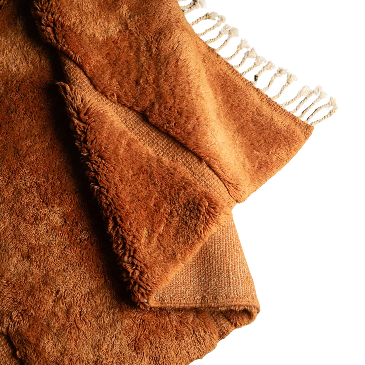 Flipped Handmade Moroccan wool rug in amber orange with organic free-form shapes and fringe