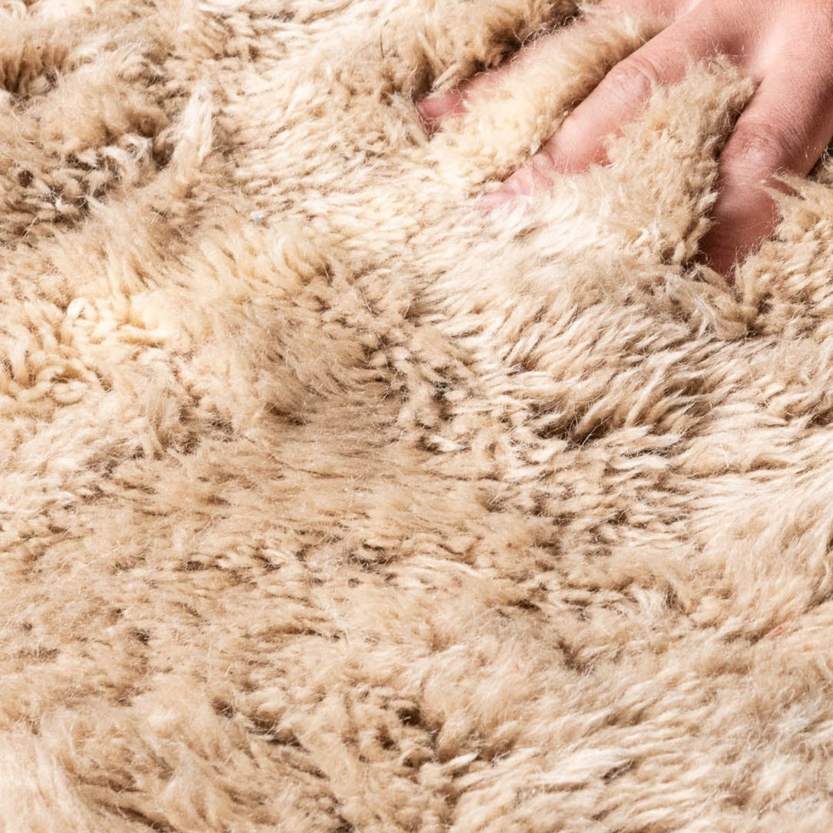 zoom on texture Handmade Moroccan wool rug in sand beige with ivory undulating line motifs