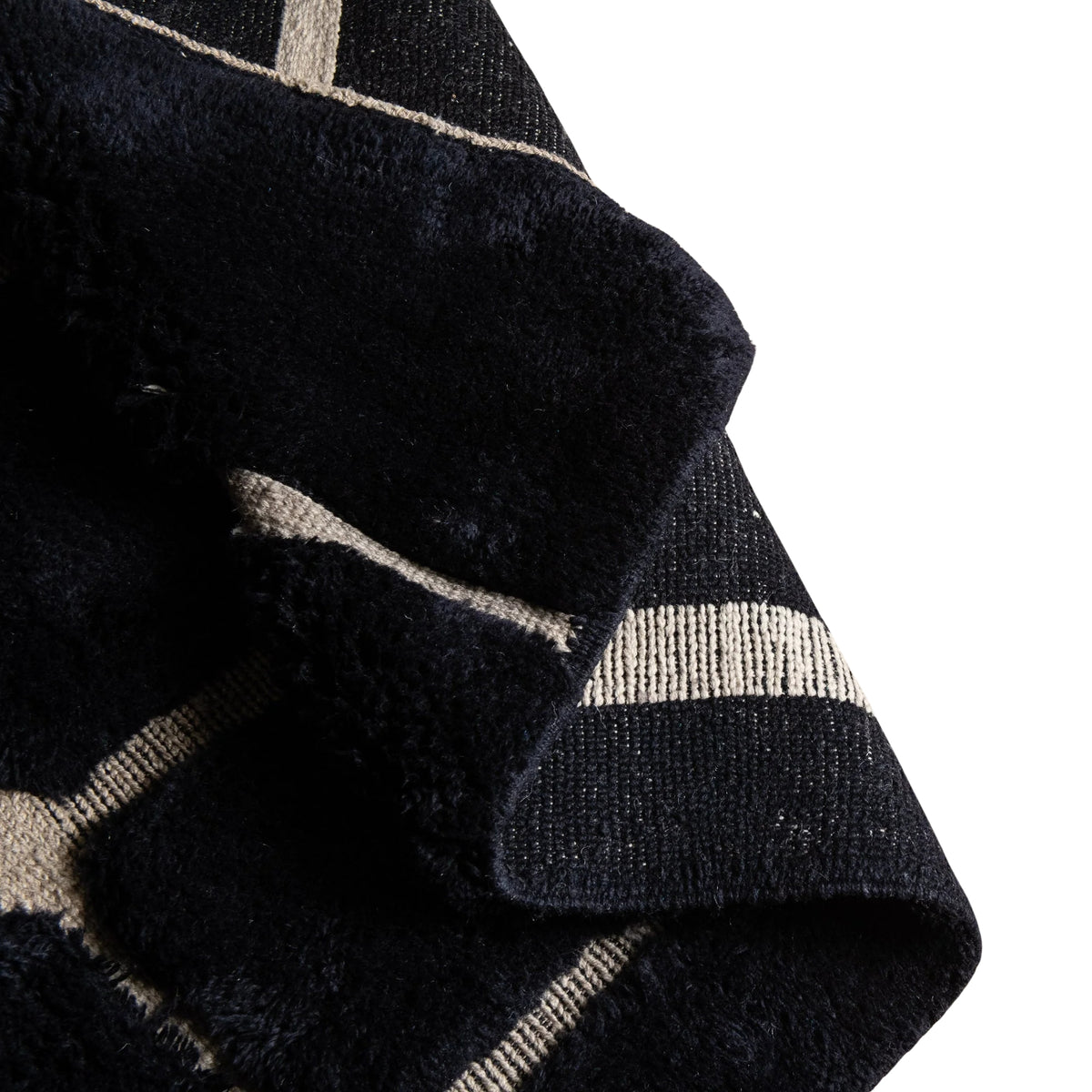 flipped Handmade Moroccan wool rug in charcoal black with beige abstract grid lines