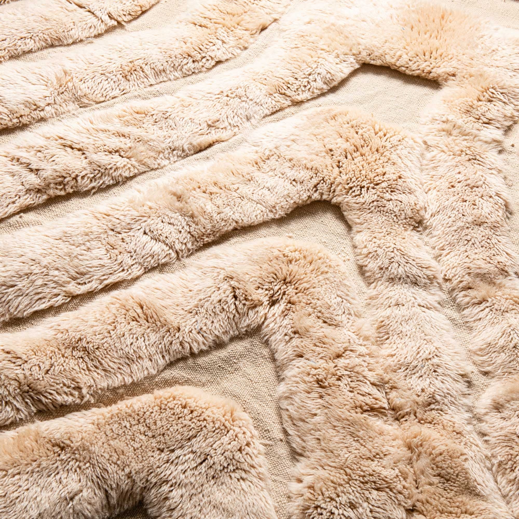 Handmade Moroccan wool rug in cream beige with concentric tonal ridges