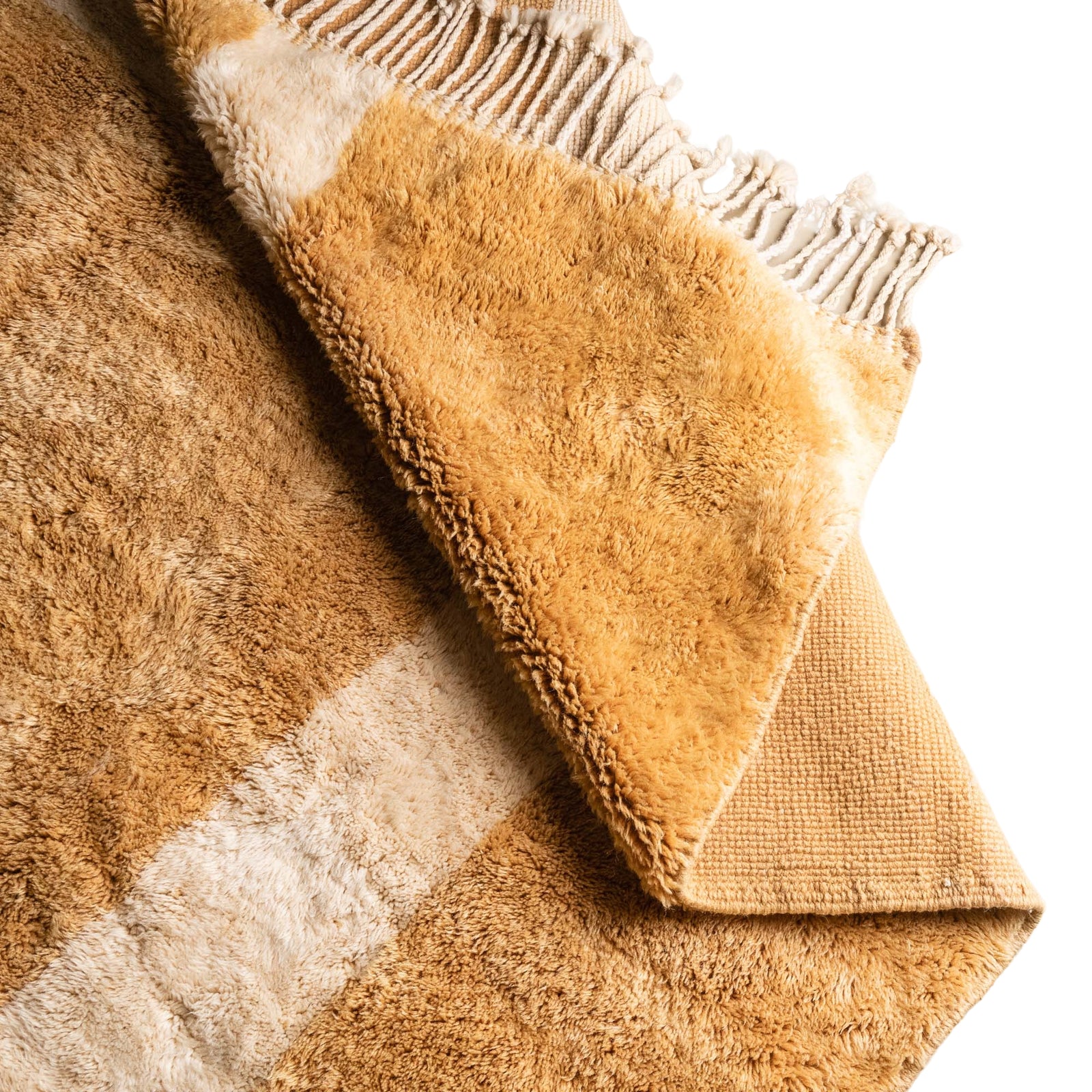 Handmade Moroccan wool rug in golden ochre and cream with bold geometric grid pattern and fringe