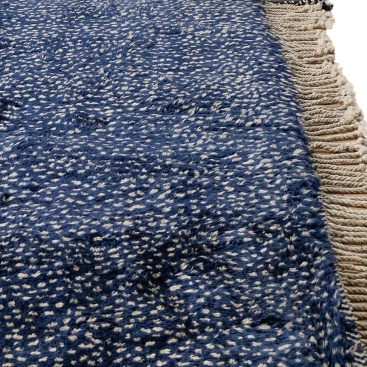 Closeup Handmade Moroccan wool rug indigo with carved ivory dot constellation pattern