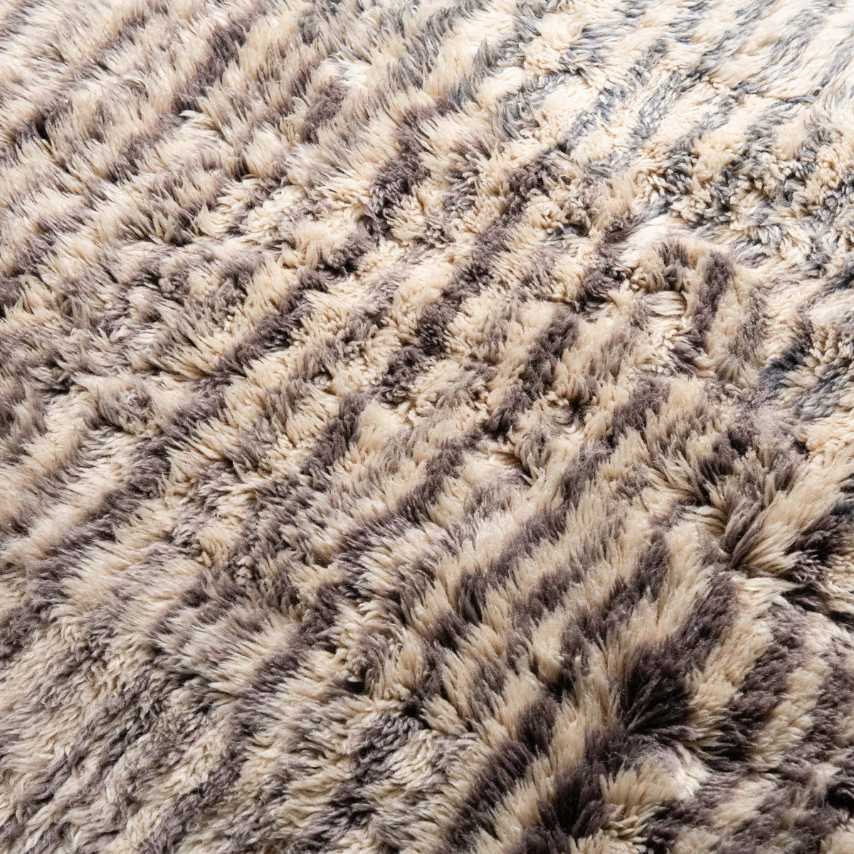 closeup Handmade Moroccan wool rug ivory with carved slate blue and taupe linear stripes