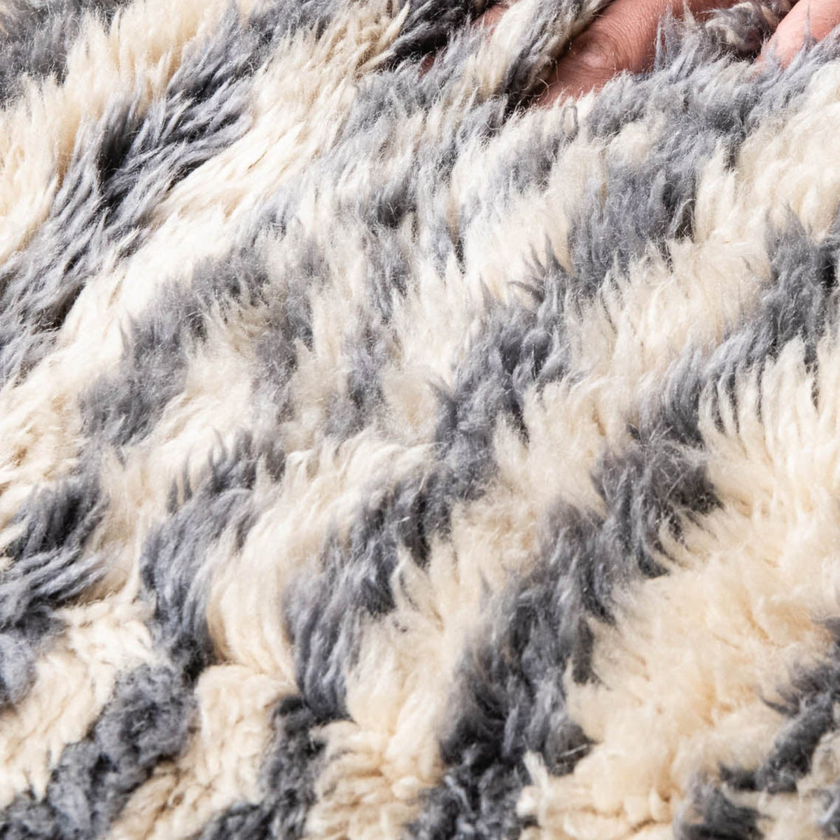 closeup Handmade Moroccan wool rug ivory with carved slate blue and taupe linear stripes