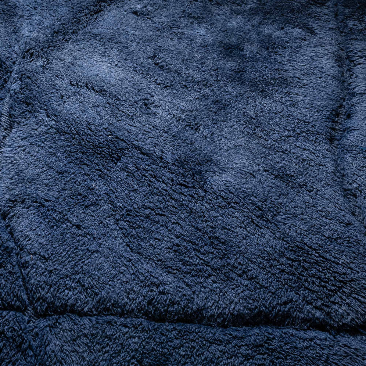 closeup Handmade Moroccan wool rug in deep navy with carved geometric relief lines