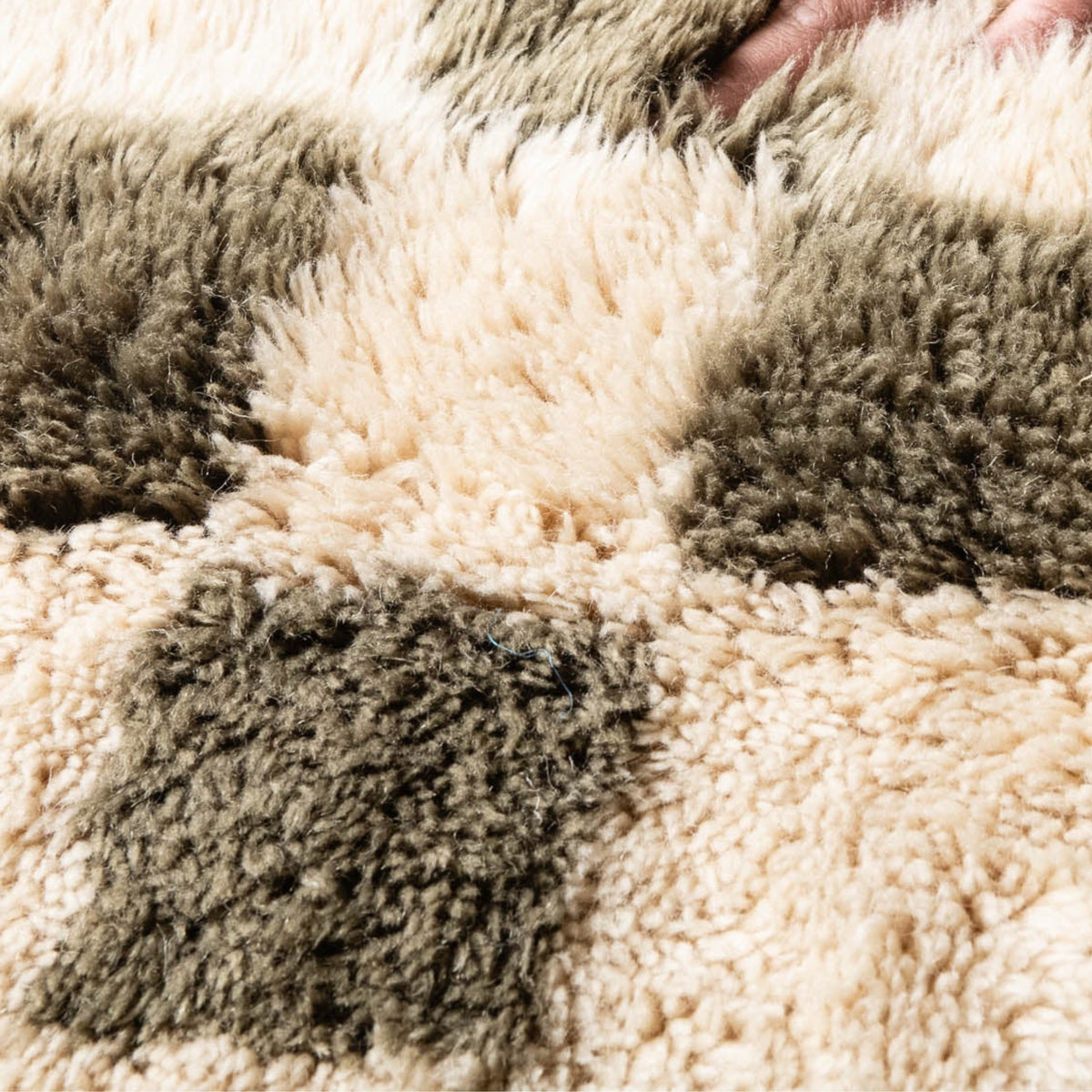 closeup Handmade Moroccan wool rug sage green with carved ivory checkerboard relief